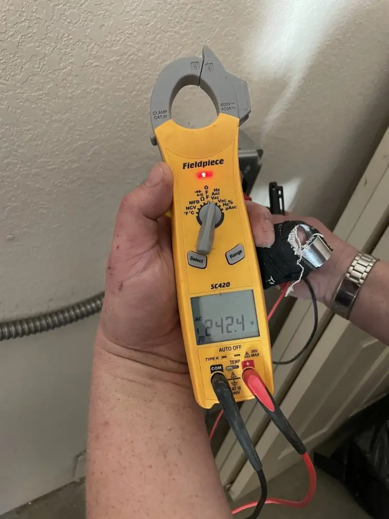 Voltage testing with clamp meter during Electrical Installation Services in Hybla Valley